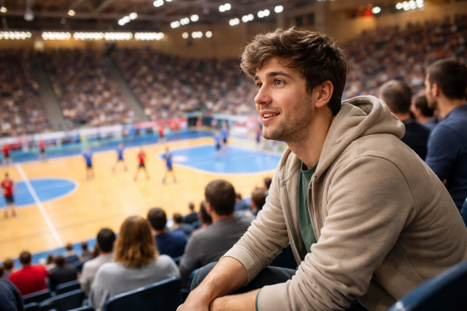 Person verfolgt ein Handball-Spiel in der Arena mit Blick auf das Spielfeld – Anfänger-Guide für Handball-Wetten